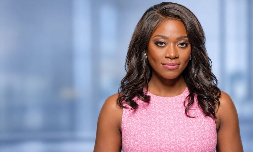 Faith Abubey wearing a pink sleeveless dress in a professional portrait.
